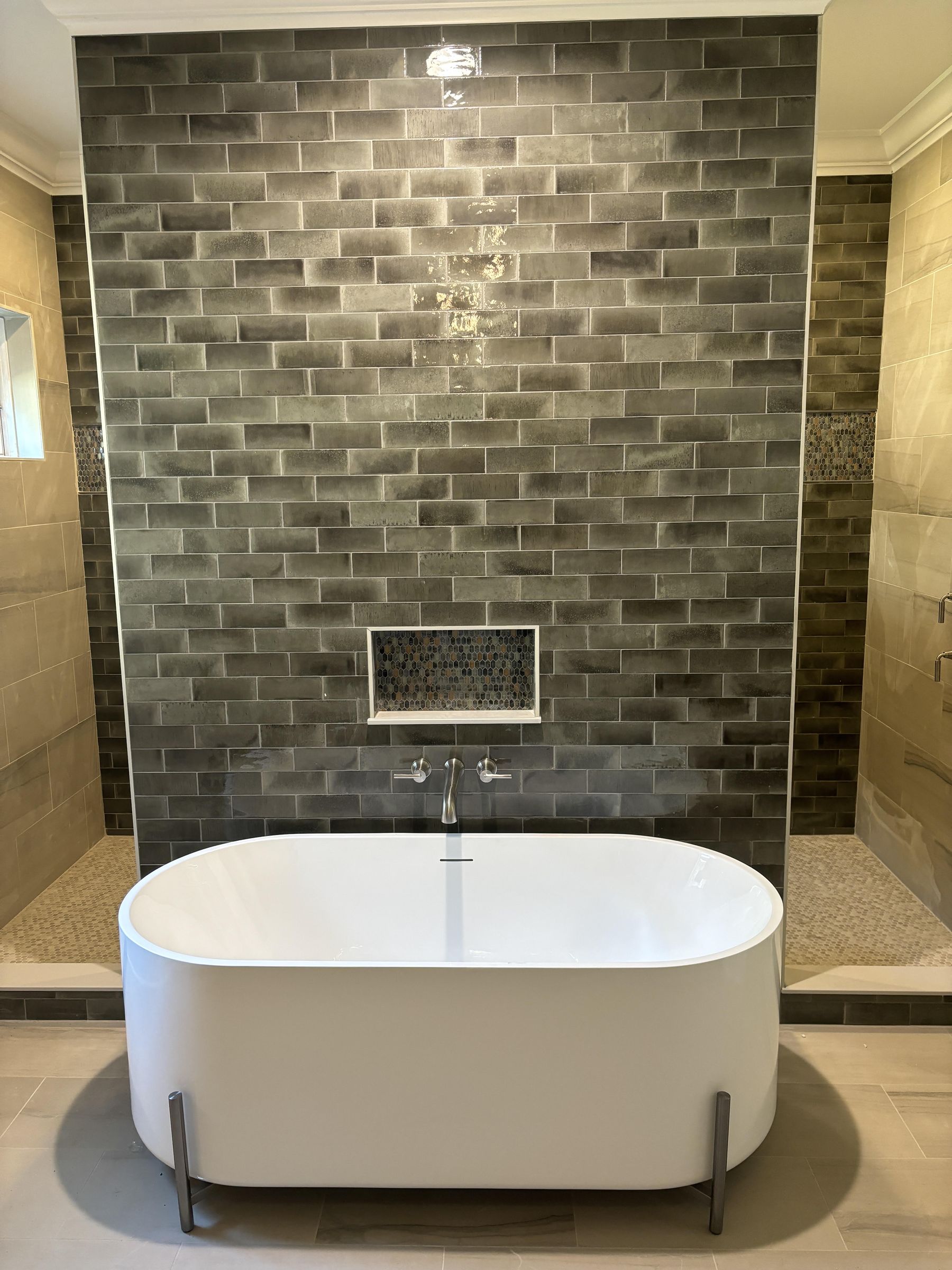 Charcoal brick tile wall behind freestanding tub