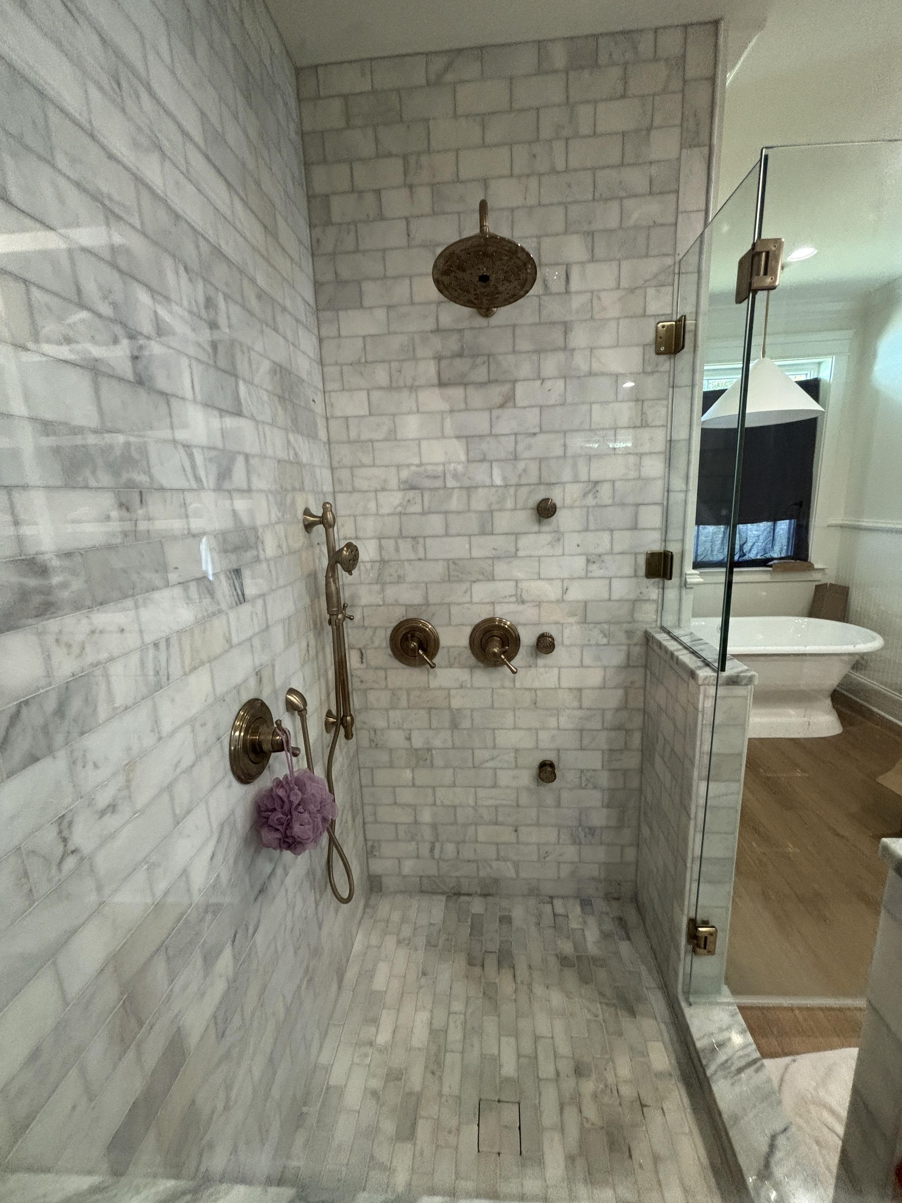 Marble subway tile shower with freestanding tub