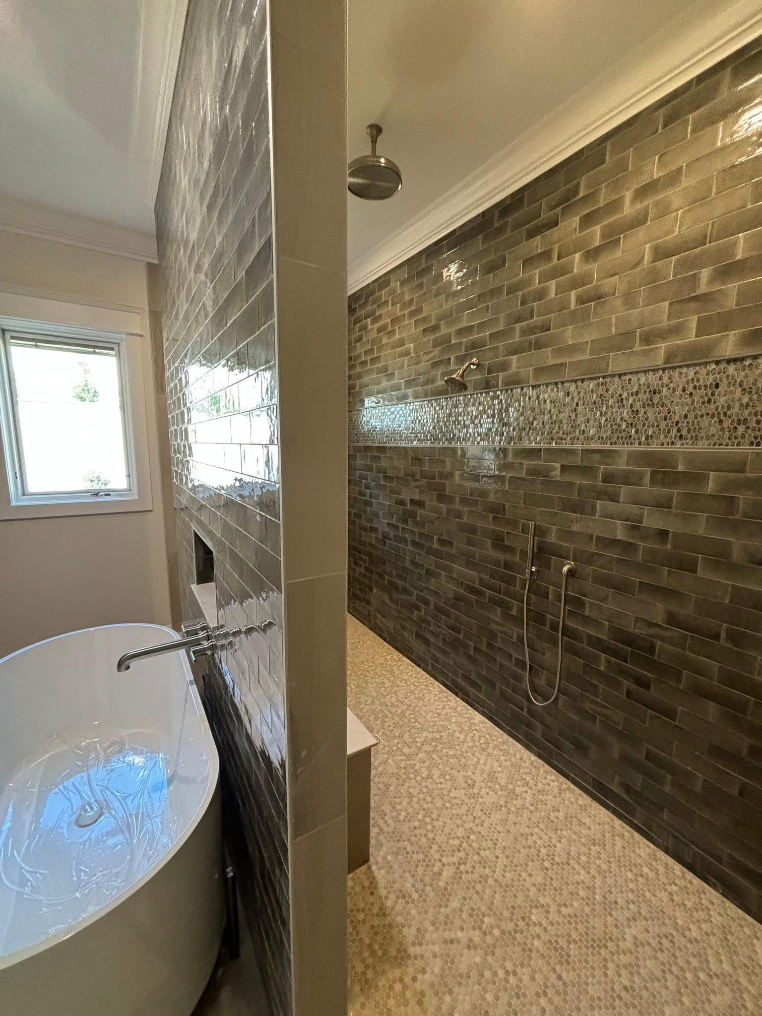 Shower with pebble tile floor and tub suite